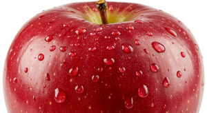 Fresh red apple with water droplets on the skin, symbolizing natural freshness and health benefits.