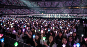  Fans waving lightsticks during a K-pop concert night scene